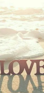 Serene beach with love letters and ocean waves in sunlight.