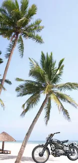 Motorcycle parked on a sunny beach with palm trees and clear blue sky.