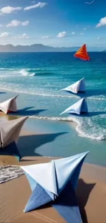 Colorful origami sculptures on a sunlit beach by the ocean.