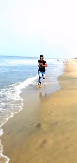 Person running on a sandy beach by the ocean under a bright sky.