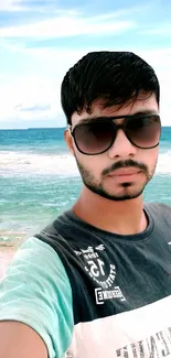 A selfie taken at a beach with ocean and sky in the background.