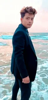 Man in suit on beach at sunset with waves.