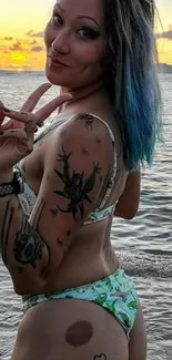 Woman with tattoos at sunset beach scene.