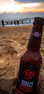 Sunset beach wallpaper with a drink bottle in the sand.