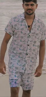 Person in tropical floral outfit with beach background.