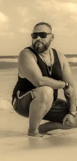 Man in sepia tone kneels on a beach with gentle waves.