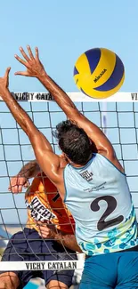 Intense beach volleyball match action with players reaching for the ball.