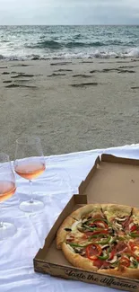 Beachfront picnic with pizza and wine