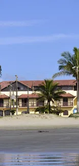 Beachfront villas with palm trees and blue sky.