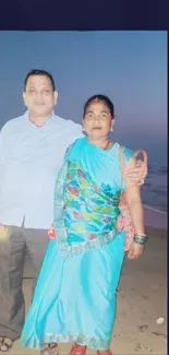 Portrait of a couple at the beach during evening with colorful attire.