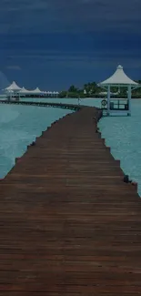 Serene wooden pier leading over tranquil blue waters towards white pavilions.