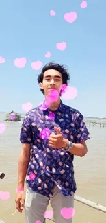 Young man enjoying scenic beachside view under clear blue sky.