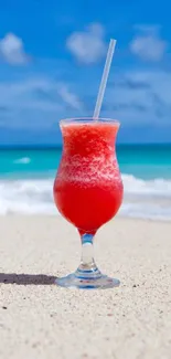 Tropical drink on sandy beach with ocean backdrop.