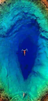 Aerial view of turquoise ocean surrounded by greenery.