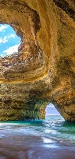 Scenic view of coastal cave with blue sky and ocean.