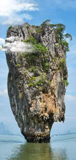 Majestic rock island under clear blue sky.