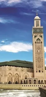 Mosque by the ocean with blue sky and waves.