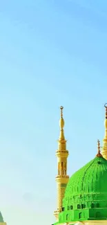 Green and blue mosque domes under a clear blue sky with golden minarets.