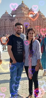 Two people posing at a temple site.