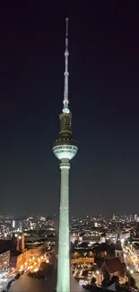 Berlin TV Tower illuminated against a dark night skyline.