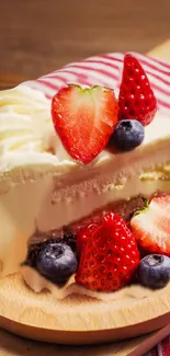 Slice of cake with fresh strawberries and blueberries on a wooden platter.