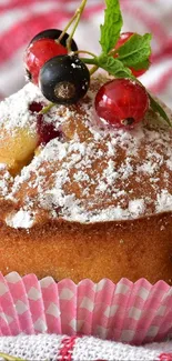 Delicious muffin topped with berries on a checkered cloth.