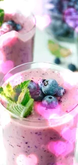 Berry smoothie with mint and blueberries, pink heart overlay.