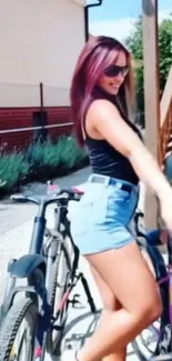 Woman in summer outfit with bicycle outdoors.