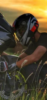 Motorcyclist in helmet next to bike at sunset in the grass.