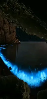 Bioluminescent lagoon at night with stars and rocky cliffs.