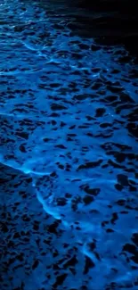 Bioluminescent ocean waves glowing in the night.