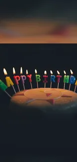 Birthday cake with candles and colorful 'Happy Birthday' letters.