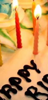 Vibrant birthday cake with lit candles.