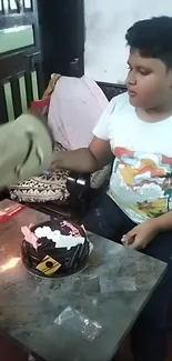 A boy and a cake at a birthday celebration moment.