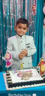 Boy celebrating birthday with cake and balloons.