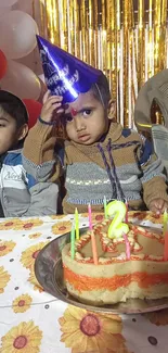 Two children enjoying a birthday with cake and party hats.