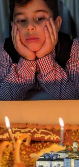 A child gazing at a birthday cake with candles and presents in the foreground.