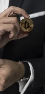 Businessman in suit holding Bitcoin with dark background.