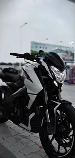 Black and white motorcycle parked in urban setting.