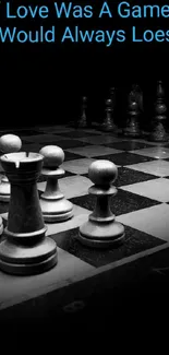 Black and white chessboard with a quote on a mobile wallpaper.
