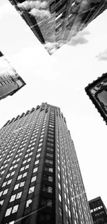 Black and white cityscape with towering skyscrapers viewed from below.