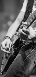 Black and white image of a musician playing an electric guitar.