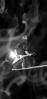 Guitarist in black and white lighting at a live concert.