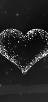 Black and white heart with sparkling effect on a dark background.