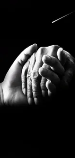 Black and white wallpaper of hands holding.