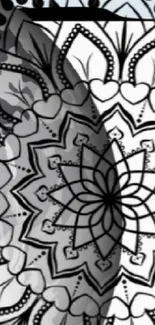 Intricate black and white mandala design on wallpaper.