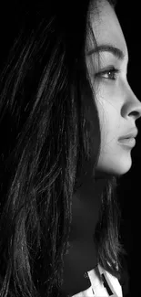 Black and white portrait of woman with side profile, emphasizing elegant features.