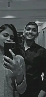 Black and white selfie of two people as mobile wallpaper.