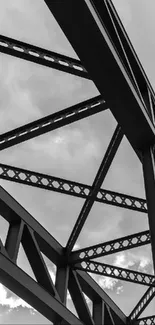 Black and white steel beams against a cloudy sky, showcasing architectural art.