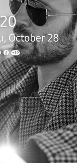 Black and white wallpaper of a bearded man wearing sunglasses.